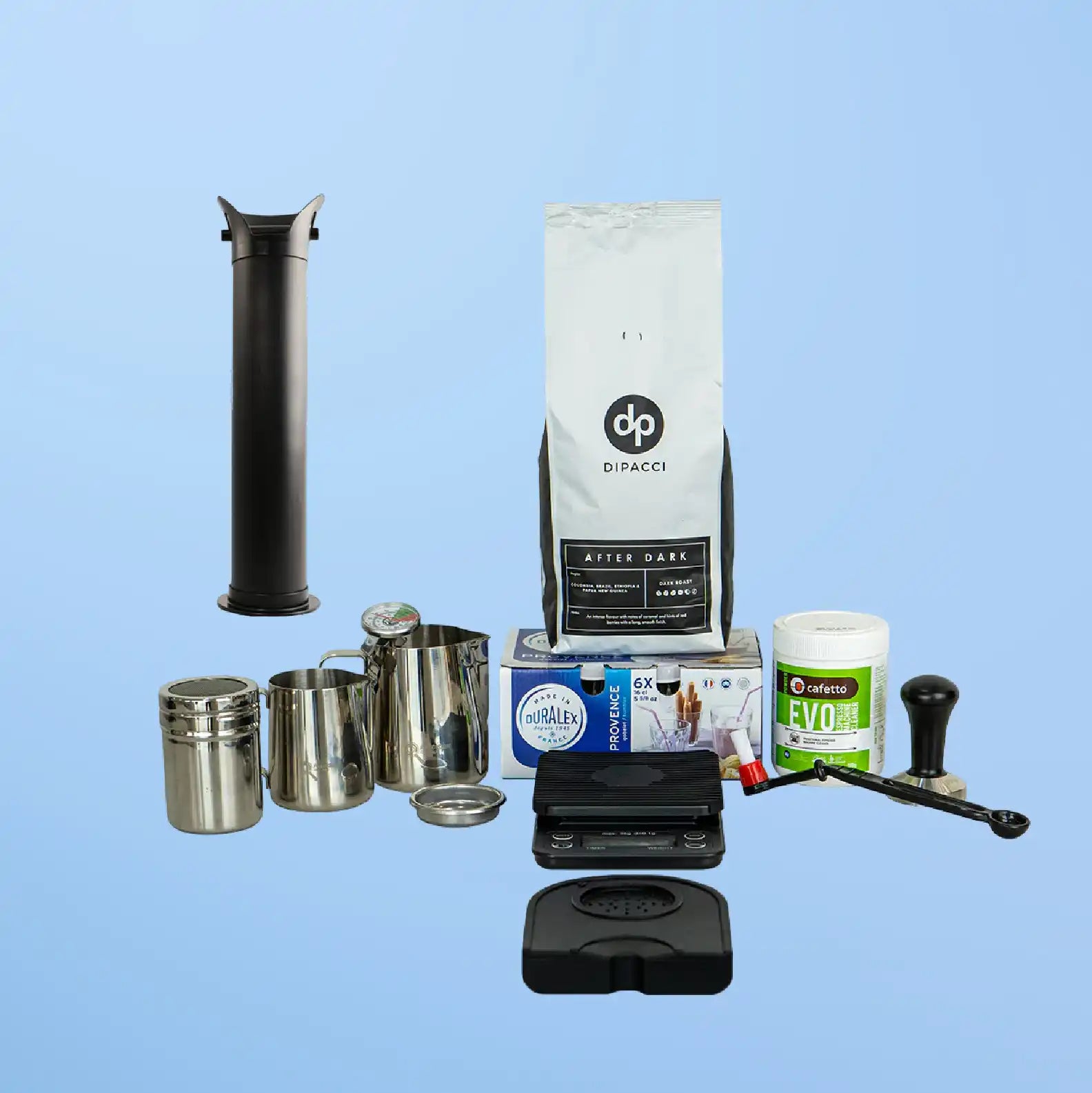 Coffee brewing equipment and supplies arranged together including a grinder, filters, beans, and storage containers.