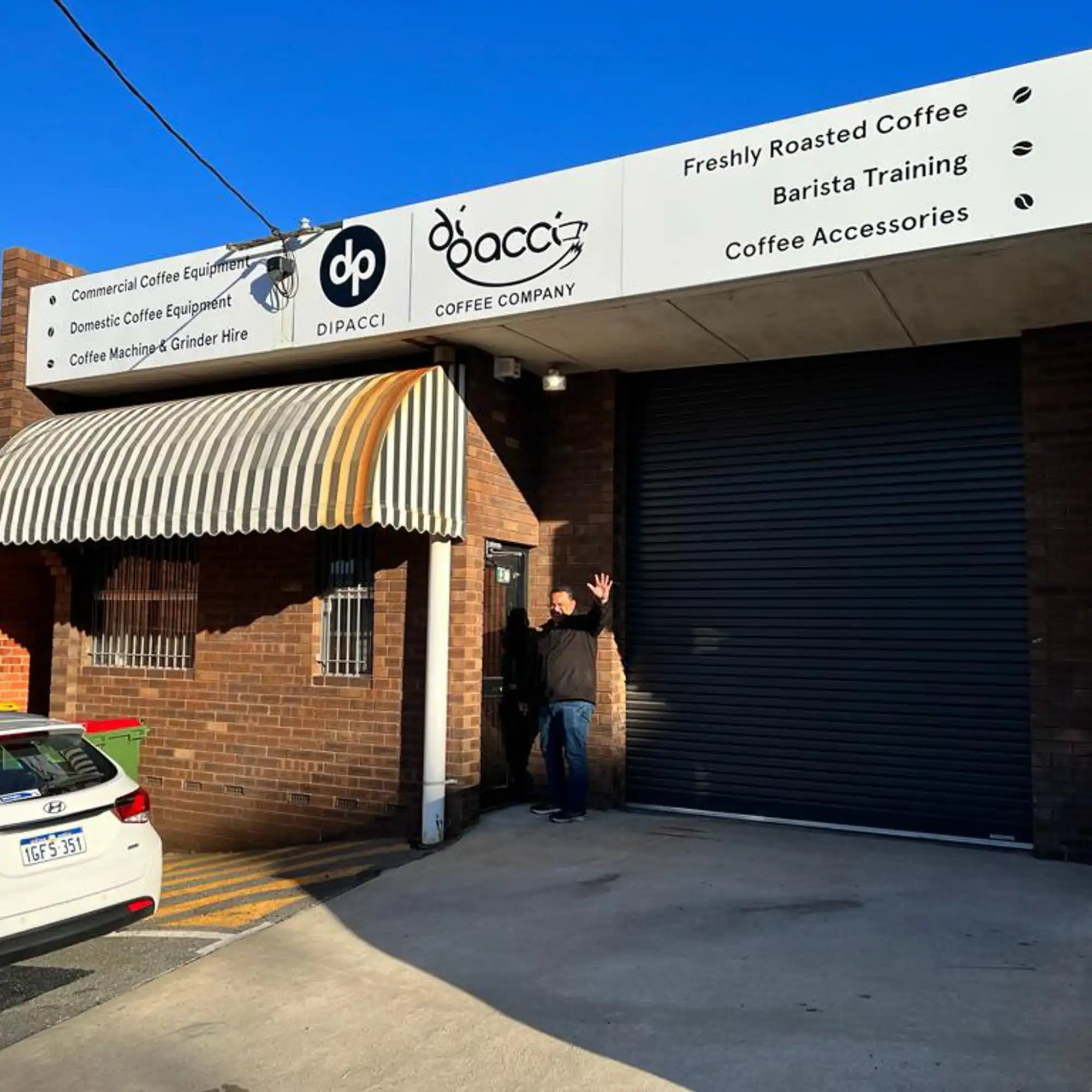 Coffee shop storefront with ’Bocca’ signage and striped awning.