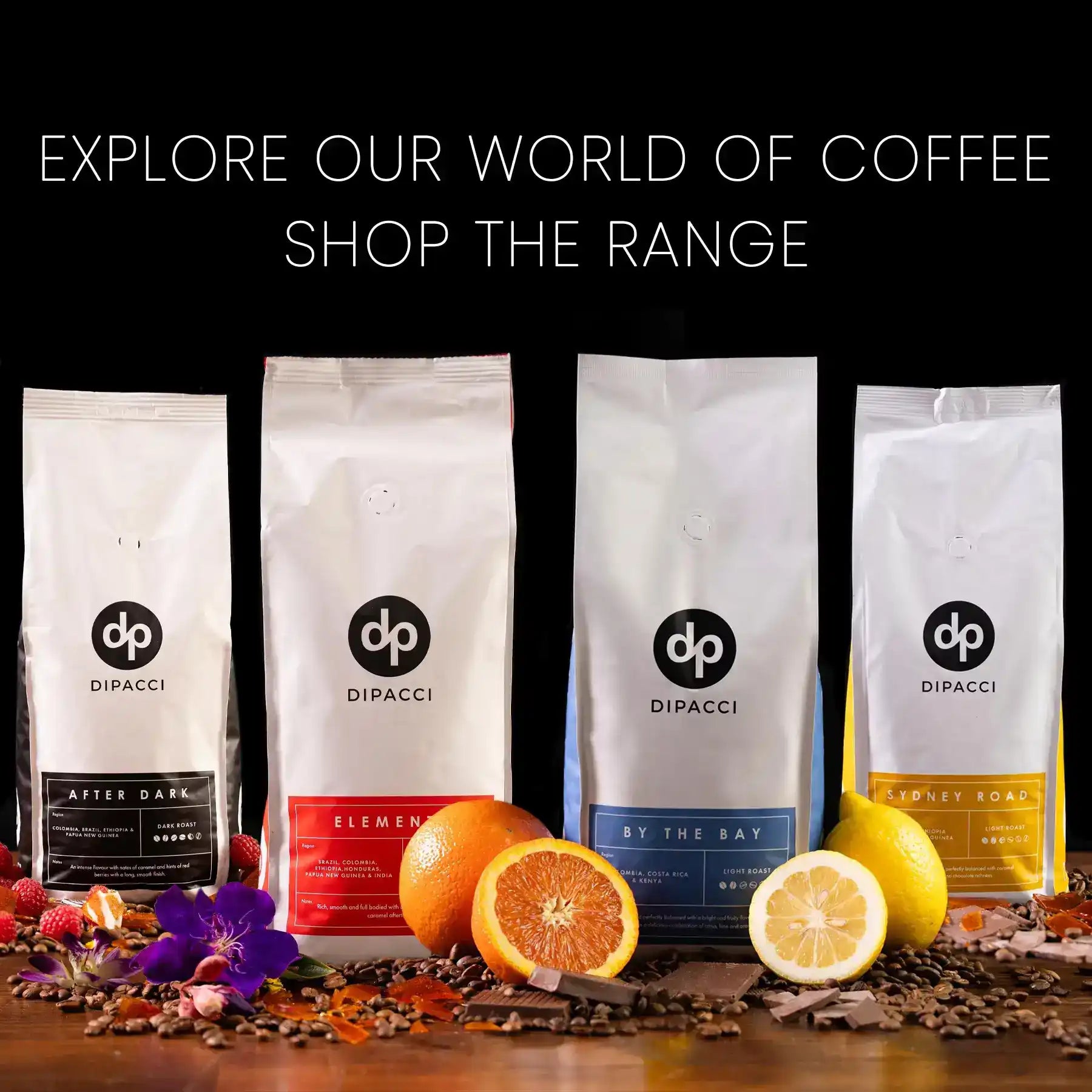 Four bags of DiPacci coffee with citrus fruits and coffee beans arranged in front.