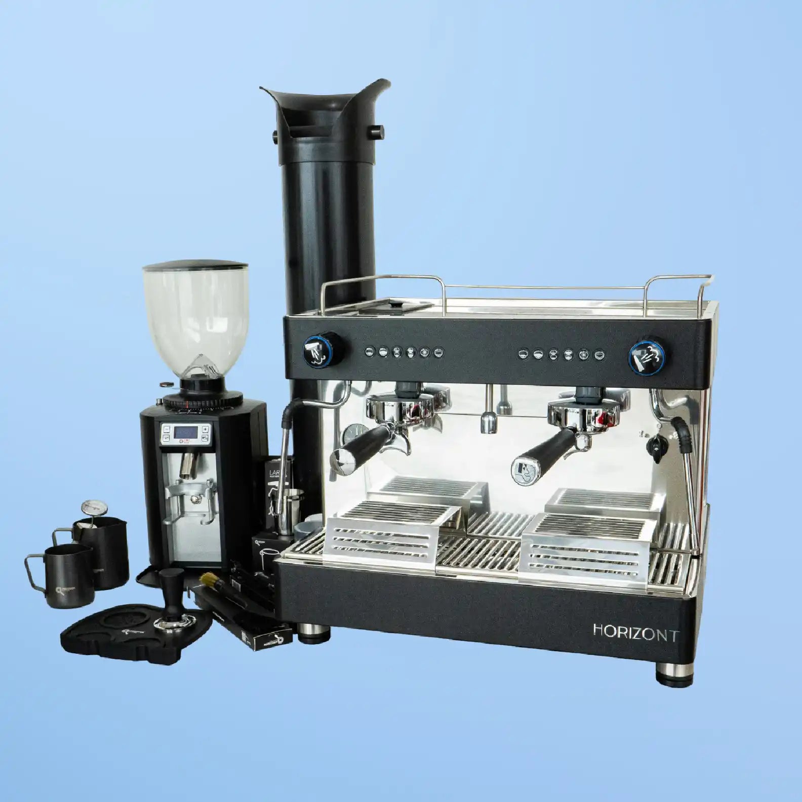 Professional dual-group espresso machine with a coffee grinder alongside it.